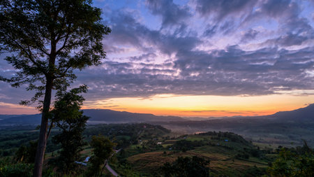 Beautiful nature landscape of the colorful sky and mountains during the sunrise at Khao Takhian Ngo View Point, Khao Kho attractions in Phetchabun, Thailandの写真素材
