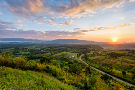 Beautiful nature landscape of the colorful sky and mountains during the sunrise at Khao Takhian Ngo View Point, Khao Kho attractions in Phetchabun, Thailandの写真素材
