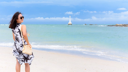 Beautiful nature landscape of the beach and sea in summer sky and cheerful woman tourist wearing sunglasse laughing with happiness on Koh Tarutao island, Satun, Thailandの写真素材