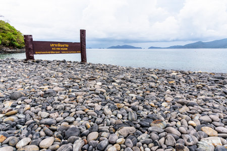 Place name plate of Ko Hin Ngam island and beautiful nature landscape of unusual rock near the sea in summer is a famous tourist attractions of Tarutao National Park, Satun, Thailandの写真素材
