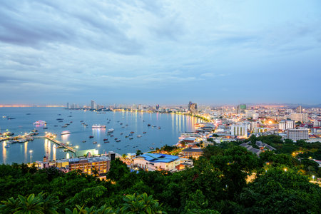High view on viewpoint see cityscape with colorful light at the beach and the sea of Pattaya Bay, beautiful landscape of Pattaya City at sunset landmark in Chonburi, Travel Asia to Thailandの写真素材