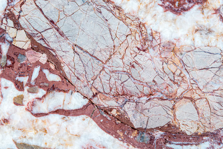 Smooth surface texture of stone, White and red line color striped wave pattern of marble, Strong structure durable nature of rock for abstract backgroundの写真素材