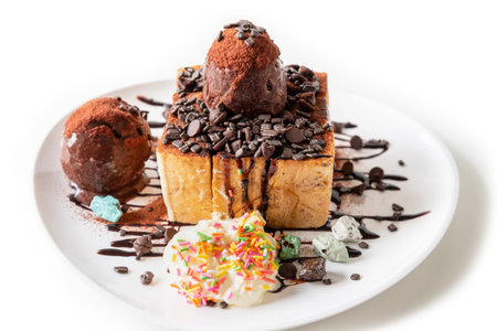 Closeup side view Honey Toast bread and Chocolate brown Ice cream scoop topped with syrup decorate with a chocolate tablet in a white plate on the table sweet cool dessert in summerの写真素材