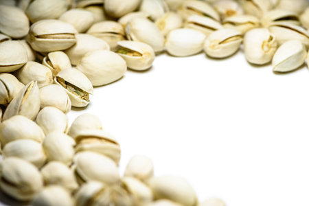 Close-up pile of beans it has a white nut shell dry and hard of Pistachio, Pistache or Pistacia vera on table food delicious salty snack copy space for white backgroundの写真素材