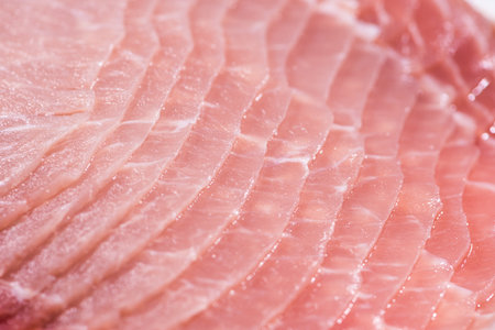 Closeup top view pieces raw meat of fresh pork slices are sliced into thin strips stacked on top of each otherの写真素材
