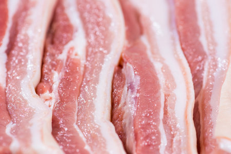 Closeup top view pieces fresh raw meat of pork belly with white fat and red pink meatの写真素材