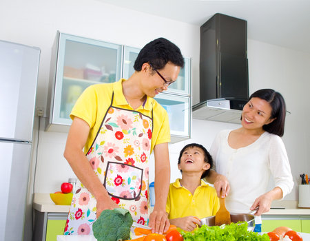 Asian family preparing vegetable for cooking in the kitchen.の写真素材