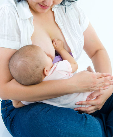 Asian mother breastfeeding her baby girlの写真素材