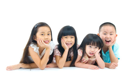 Asian kids lying on the floorの写真素材