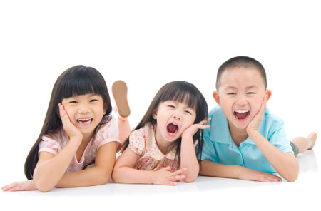 Asian kids lying on the floorの写真素材