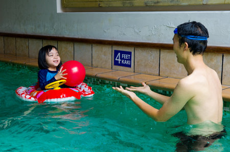 in swim tube playing on swimming poolの写真素材