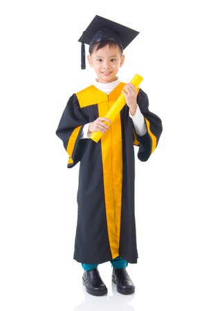 Asian kid in graduation gownの写真素材