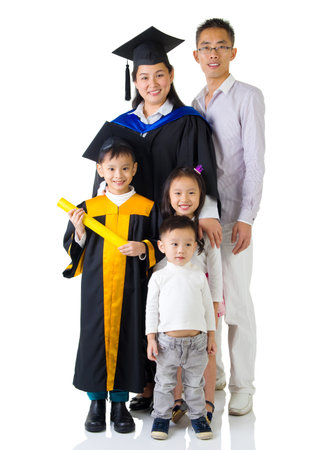 Asian mother and son in graduation gown.Taking photo with family.の写真素材