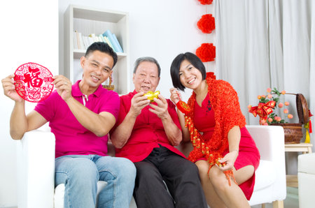 Asian senior man and children celebrating chinese new yearの写真素材