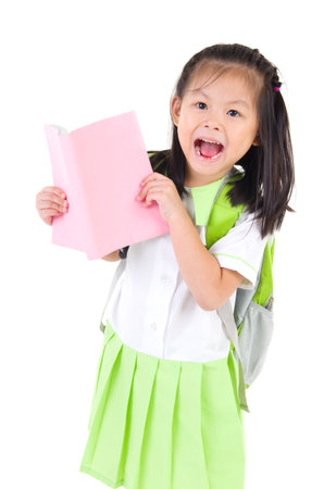 Happy little schoolgirl with books isolated on white backgroundの写真素材