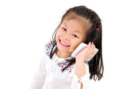 Little asian girl talking with smartphoneの写真素材