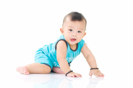 crawling beautiful baby boyの写真素材