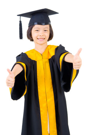 Asian kid in graduation gownの写真素材