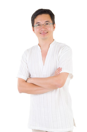 Confident Asian man crossed arms over white backgroundの写真素材