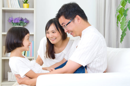 Asian family having fun at homeの写真素材