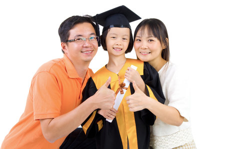 Asian kid in graduation gown.Taking photo with family.の写真素材