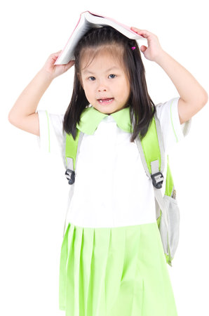 Happy little schoolgirl with books isolated on white backgroundの写真素材