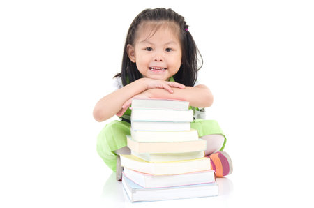 Happy little schoolgirl with books isolated on white backgroundの写真素材