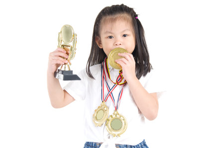 Portrait of asian girl with medals around neck and handの写真素材