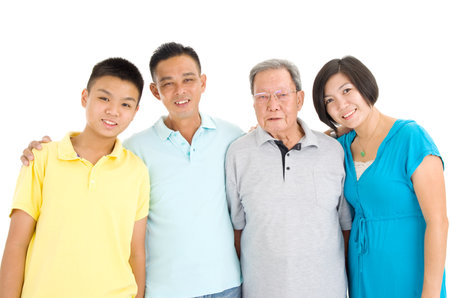 Indoor portrait of beautiful asian 3 generations family over white backgroundの写真素材