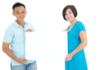 Middle Couple Holding a Blank Signの写真素材