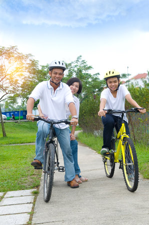 Asian Family On Cycle Ride In Countrysideの写真素材
