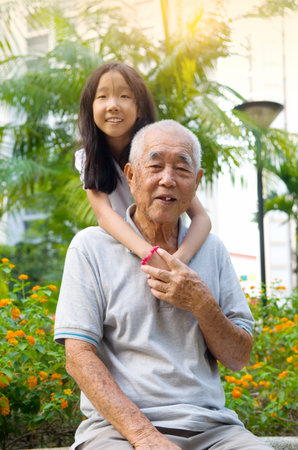 Asian Grandfather posing with grandchildrenの写真素材
