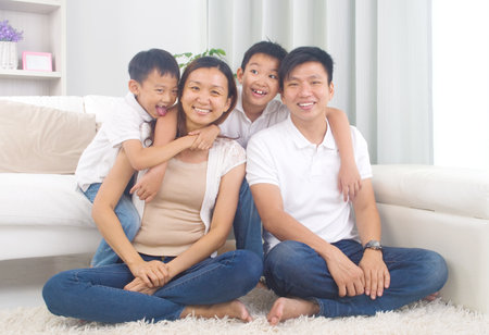 Indoor portrait of asian mixed race familyの写真素材