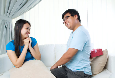happy young man gives a gift to girlfriendの写真素材