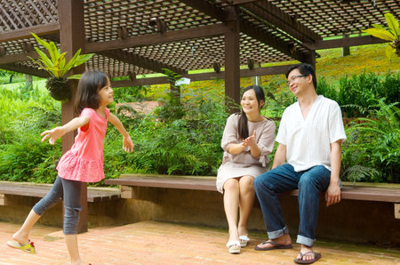 Happy Asian Family enjoying their time in the parkの写真素材