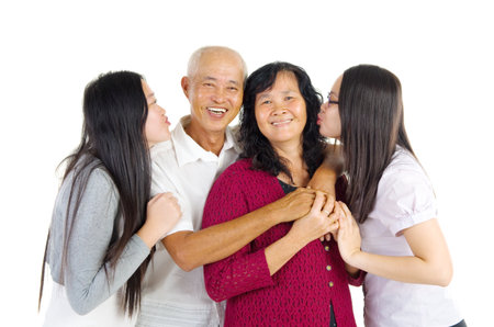 Asian parent and their daughters indoor portraitの写真素材