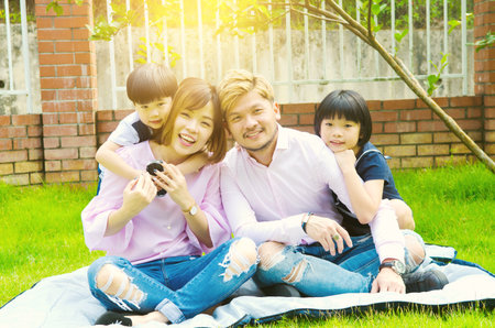 Outdoor portrait of a happy asian familyの写真素材
