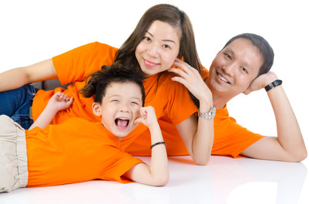 Asian family lying on the floor and smiling,isolated on white backgroundの写真素材