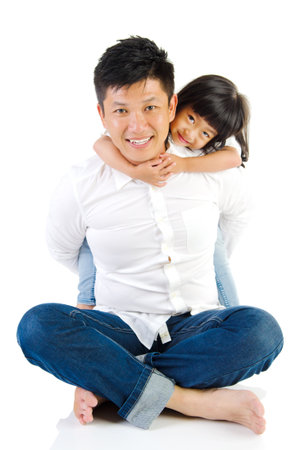 Asian father and his cute little girl isolated on white backgroundの写真素材