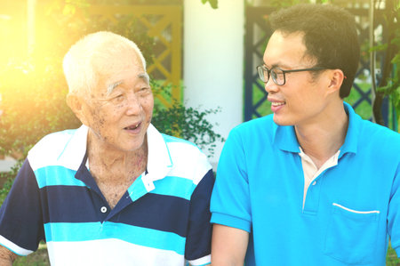 Happy asian family relaxing in the garden.Senior man smiling.の写真素材