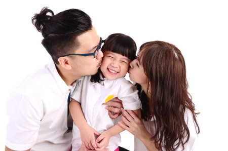 asian parent kissing their cute little girlの写真素材