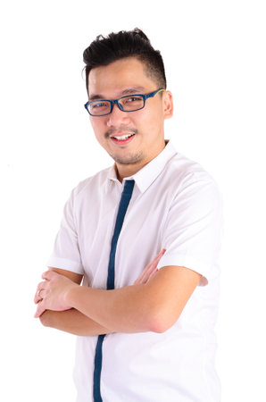 Confident Asian man crossed arms over white backgroundの写真素材
