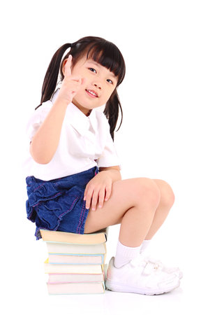 Asian girl  sitting on the floor with booksの写真素材