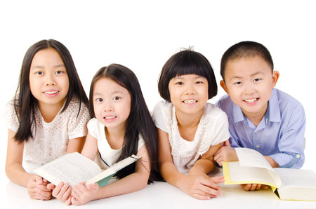 Lovely asian girls lying on the floor reading booksの写真素材