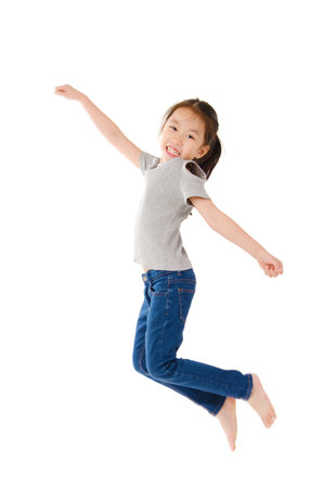happy girl jumping and isolated on white backgroundの写真素材