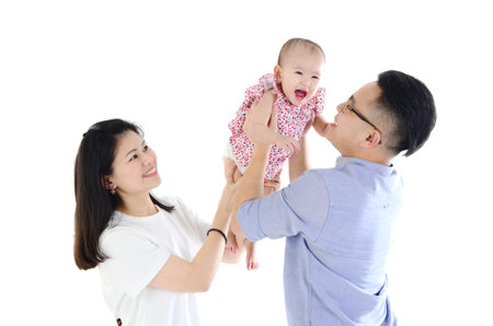 Happy family carry their daughter and having fun