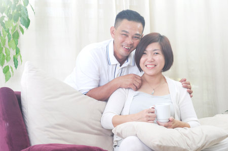 Happy Asian Middle age couple  in love having a good time at homeの写真素材