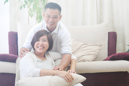 Happy Asian Middle age couple  in love having a good time at homeの写真素材