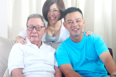 Asian senior father with his adult son and daughter at home. Family living lifestyle.の写真素材