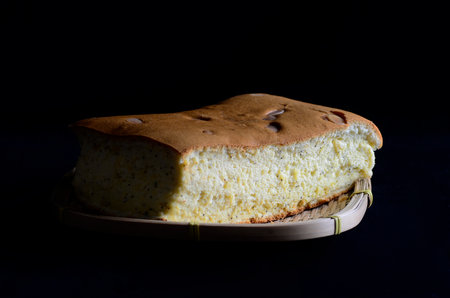 Taiwanese  lemon sponge cake  on wooden basket isolated on black backgroundの写真素材